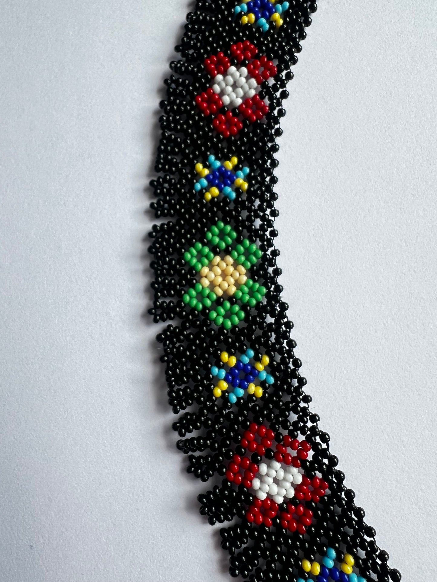 Vyshyvanka heritage sylianka necklace with black base and colored designs close up on details