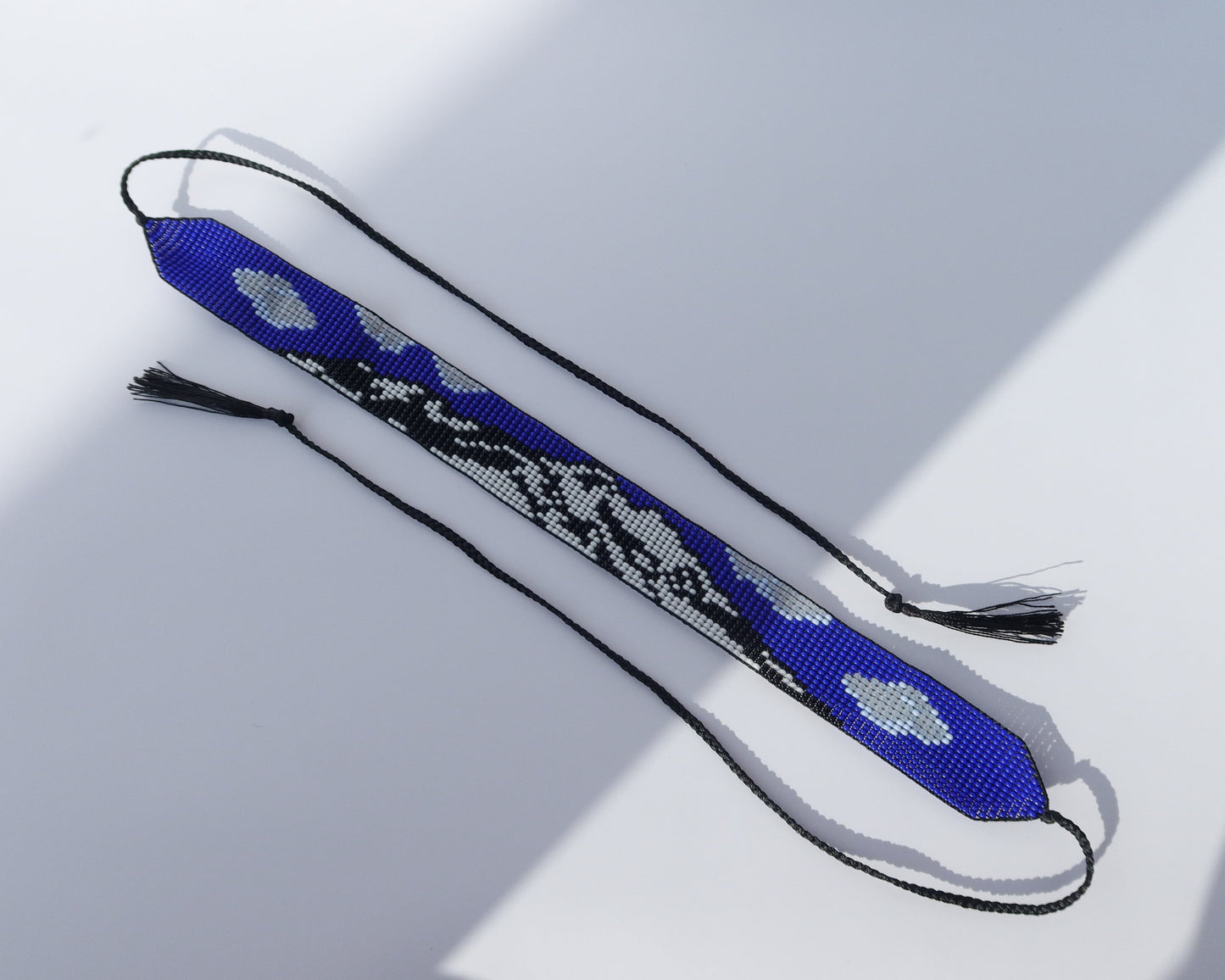 Comely UA blue, white, and black beaded gerdan necklace with Mont Blanc mountain pattern and tassels.