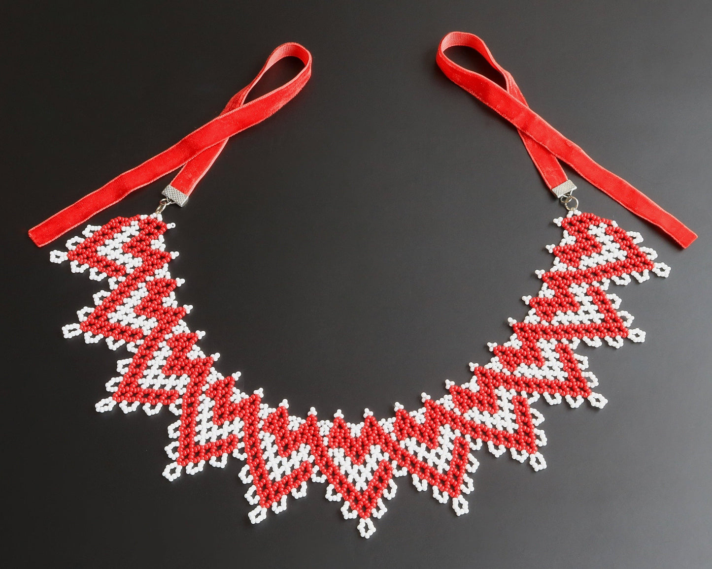Comely UA red and white zigzag beaded silyanka necklace with velvet ribbon ties. Symbolizes warmth and renewal.