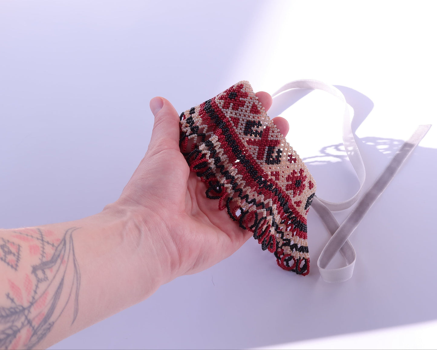 Comely UA Silyanka beaded necklace in red, black, and cream with diamond and cross motifs. Traditional Ukrainian adornment.