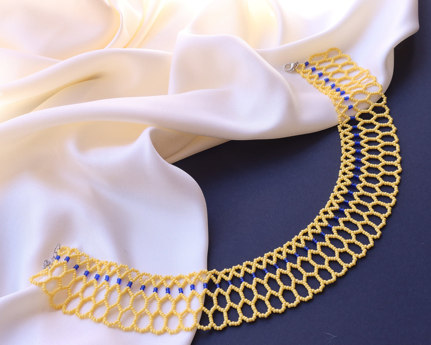Comely UA yellow and blue beaded lace choker necklace, inspired by Ukrainian beadwork. Features an openwork honeycomb pattern.