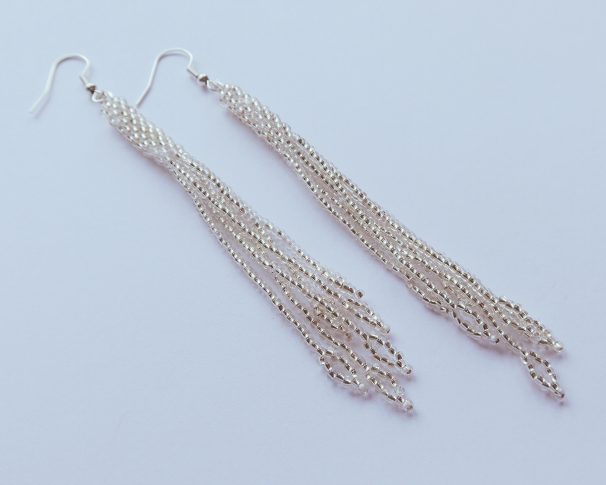 Silver chain earrings on a light blue background