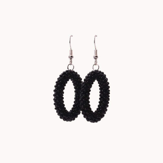 Black beaded hoop earrings on a white background
