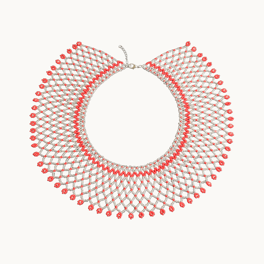 Necklace with red and silver beads on a white background