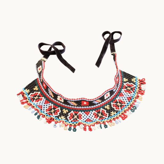 Colorful beaded necklace with tassels on a white background