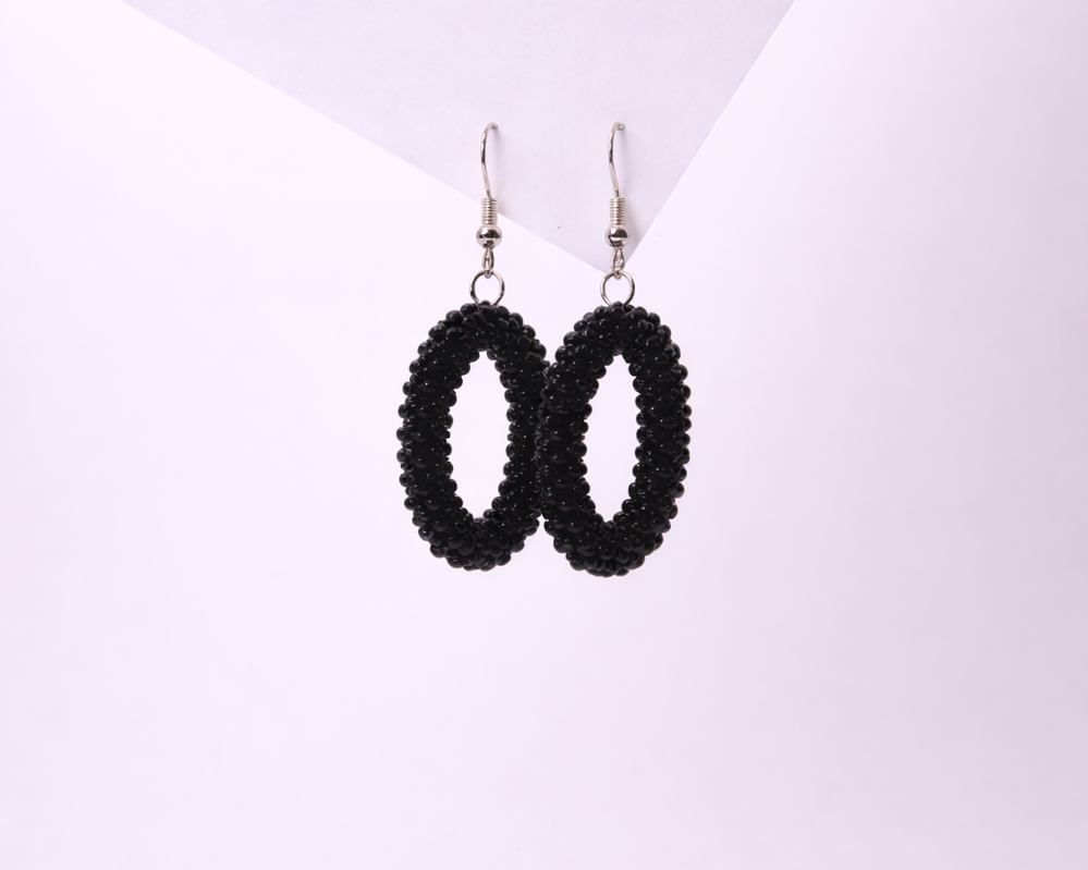 Black beaded earrings on a white background