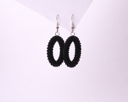 Black beaded earrings on a white background