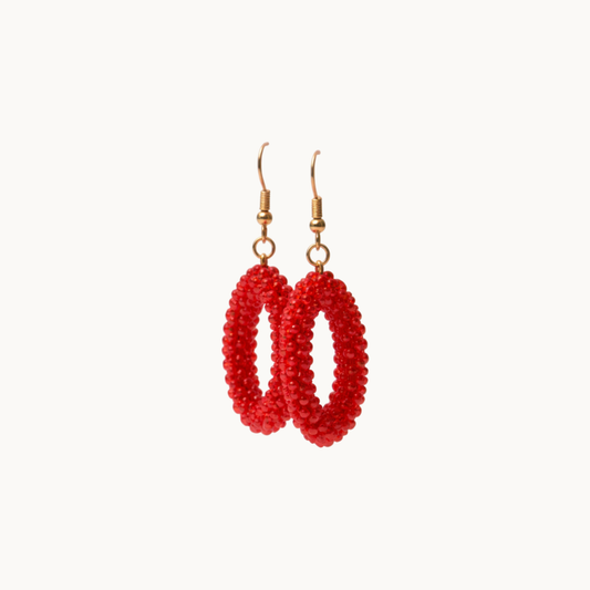 Red beaded earrings on a white background