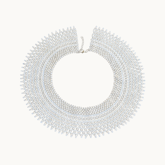 White beaded necklace on a white background