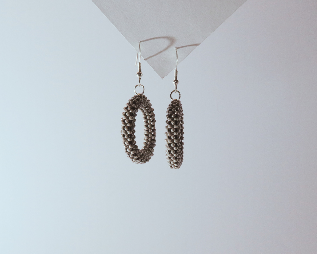 Pair of hoop earrings on a light gray background