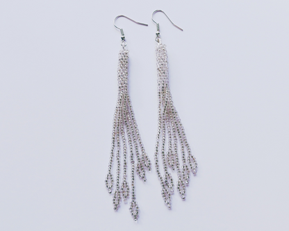 Silver chain earrings on a light gray background