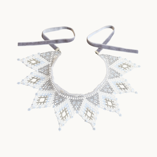 Decorative silver necklace on a white background