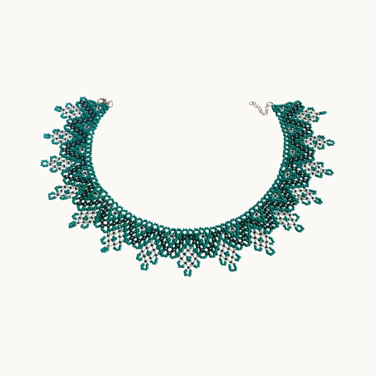Teal beaded necklace on a white background