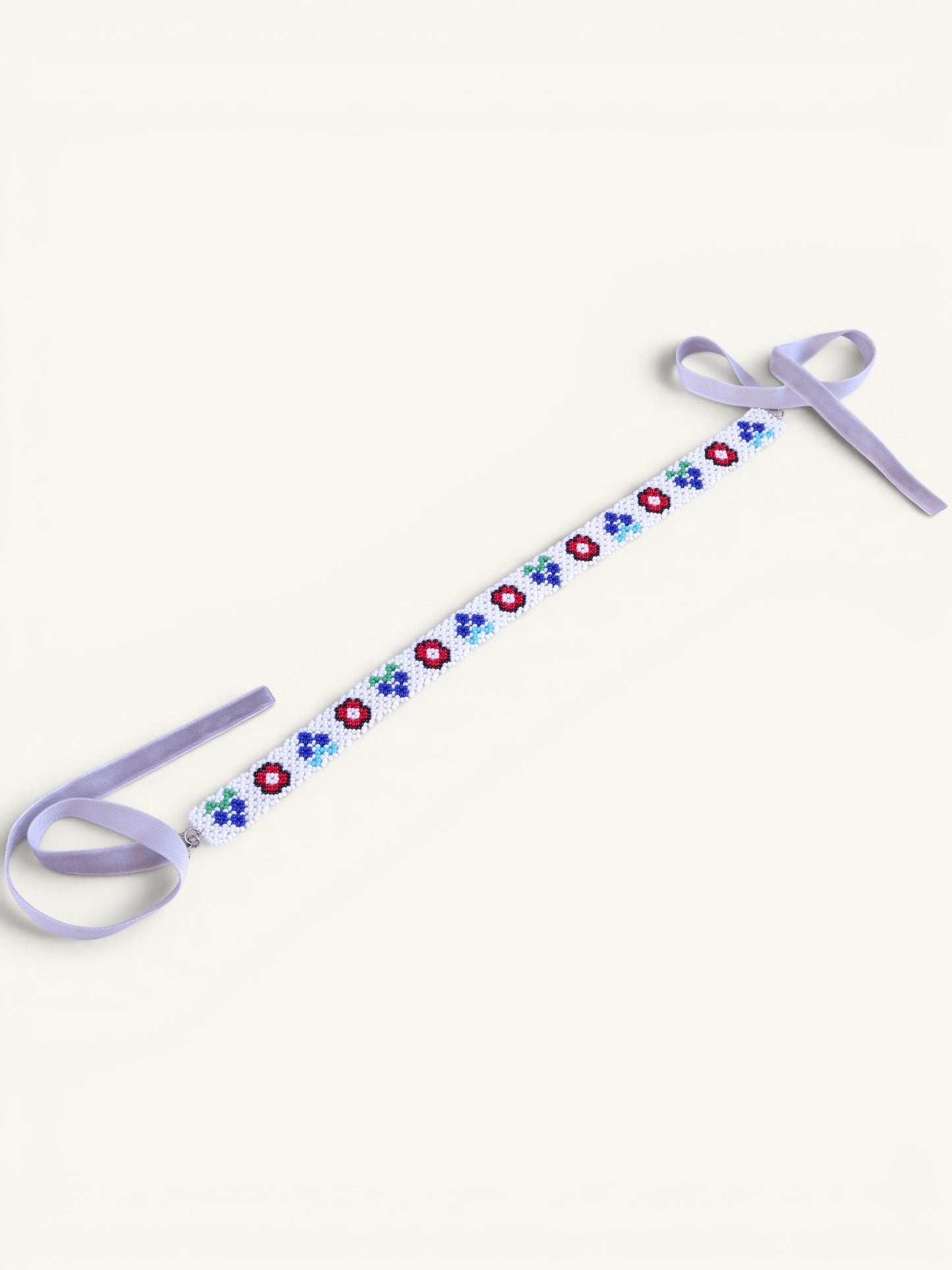 Comely UA white beaded gerdan necklace with red, blue, and green floral motifs and lavender velvet ribbons.