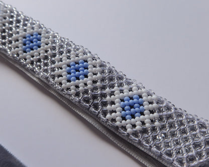 Comely UA beaded gerdan necklace with blue, white, and clear Czech seed beads in a rhombic pattern on a velvet ribbon.