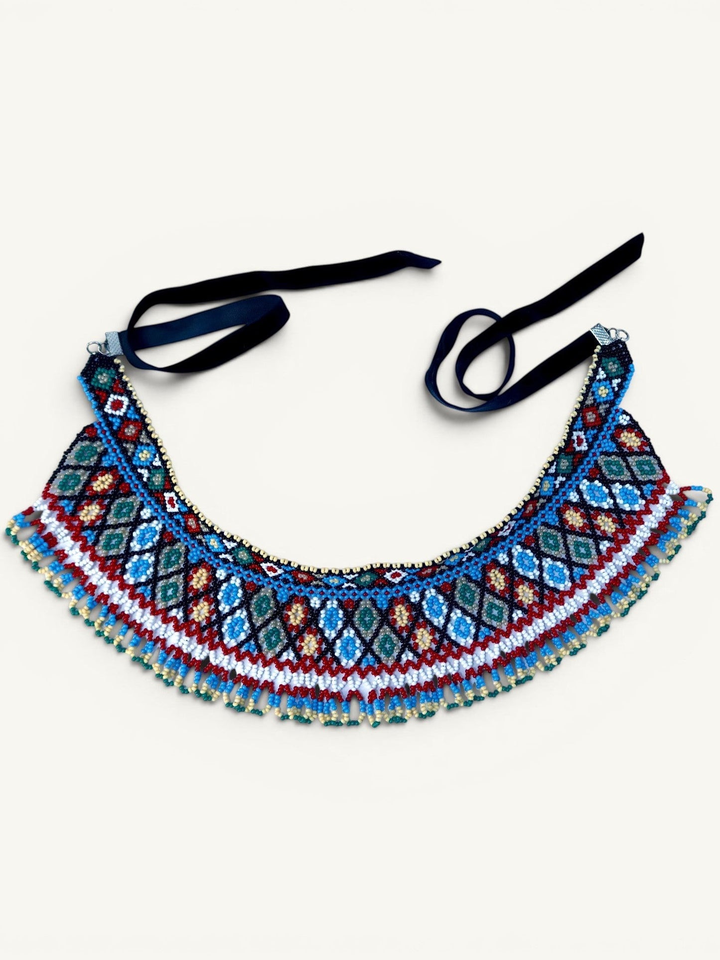 Comely UA two-part beaded necklace with geometric diamond pattern in red, blue, white, and green Czech seed beads, finished with velvet ribbons.