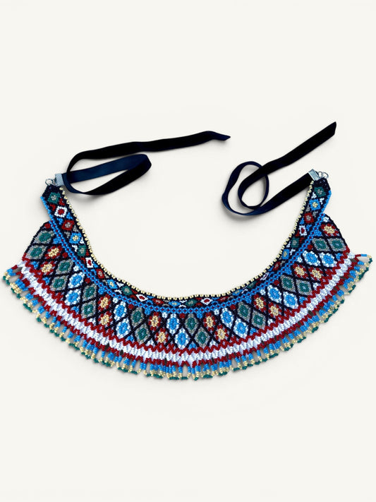 Comely UA two-part beaded necklace with geometric diamond pattern in red, blue, white, and green Czech seed beads, finished with velvet ribbons.