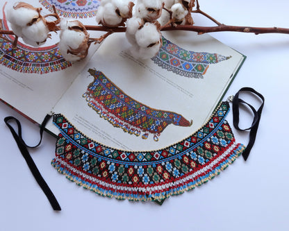 Comely UA two-part beaded necklace with red, black, blue, green, and white Czech seed beads on nylon thread with velvet ribbons.
