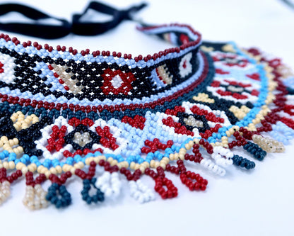 Comely UA beaded silyanka necklace with ladder motif, red, black, white, blue, and yellow beads, fringe detail.