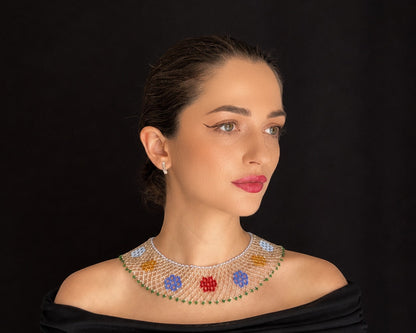 Comely UA beaded silyanka necklace with red, blue, yellow, and green floral motifs on a white mesh. Replica of a 20th-century talisman.