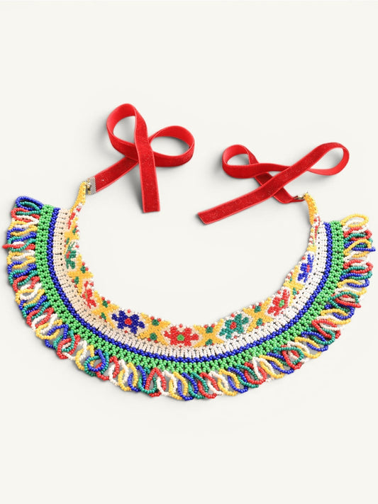 Comely UA beaded silyanka necklace with floral motifs in yellow, green, red, blue, and white. Features red velvet ribbons.