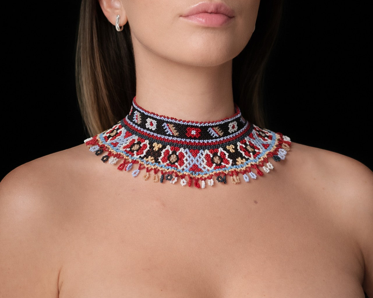 Comely UA beaded Silyanka necklace with red, black, white, blue, and yellow geometric patterns and fringe detail.