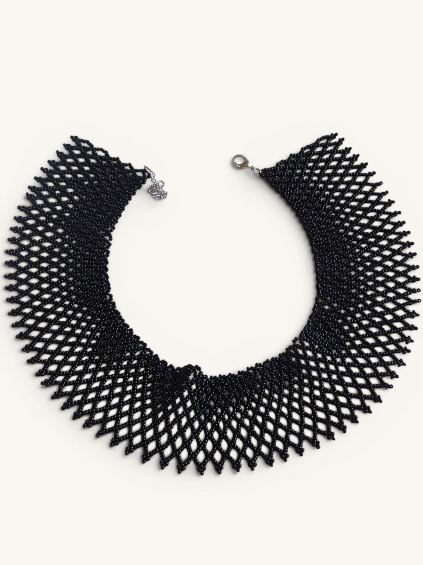 Comely UA black beaded necklace, a flat woven choker with a diamond pattern and silver clasp.