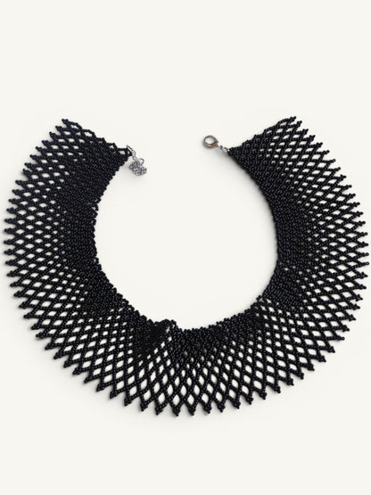Comely UA black beaded necklace, a flat woven choker with a diamond pattern and silver clasp.