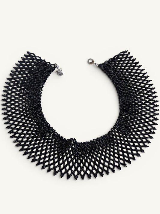 Comely UA black beaded necklace, a flat woven choker with a diamond pattern and silver clasp.