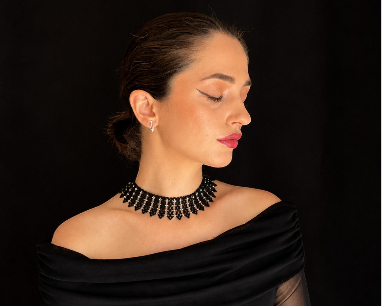 Comely UA black and silver beaded necklace with geometric pointed elements, inspired by Ukrainian design.