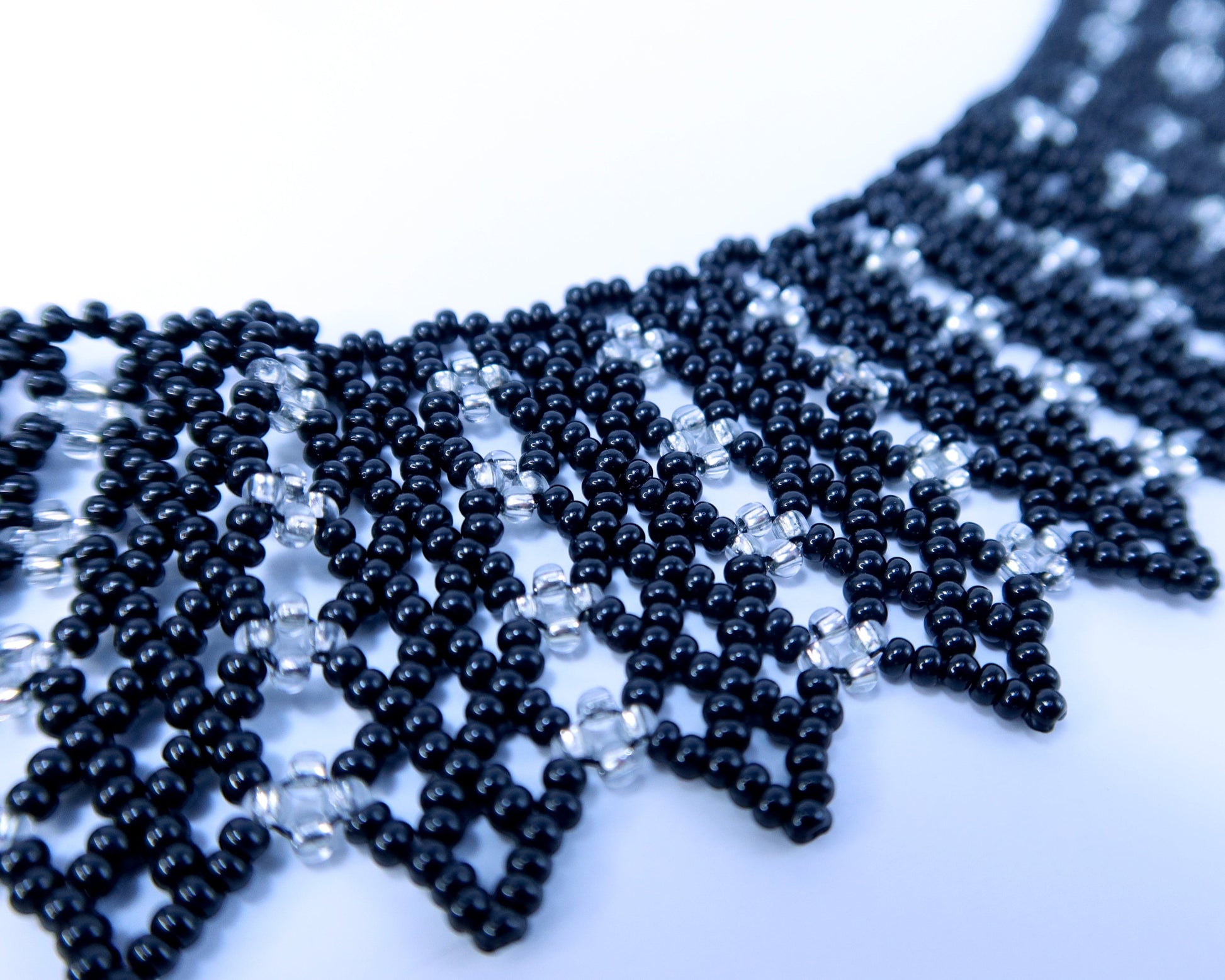 Comely UA black and silver beaded necklace with geometric pattern, inspired by Ukrainian design.