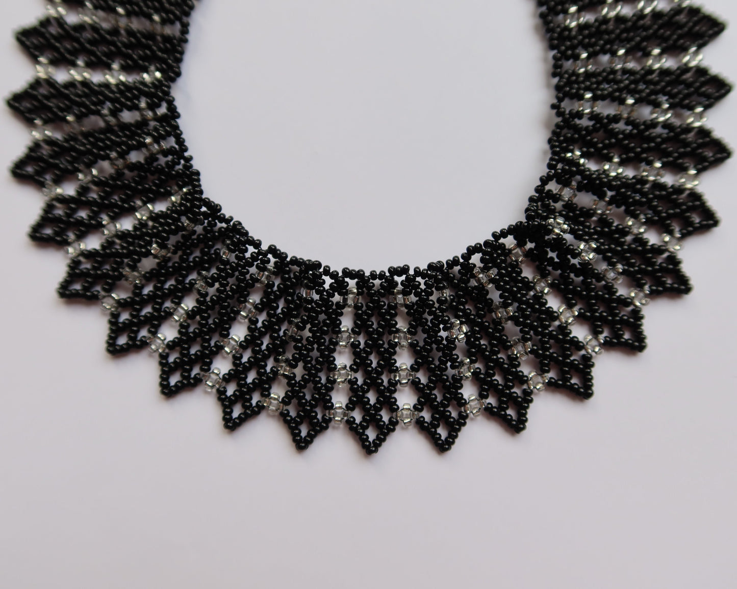 Comely UA black and silver beaded necklace with geometric pattern, inspired by Ukrainian design. Adjustable clasp.