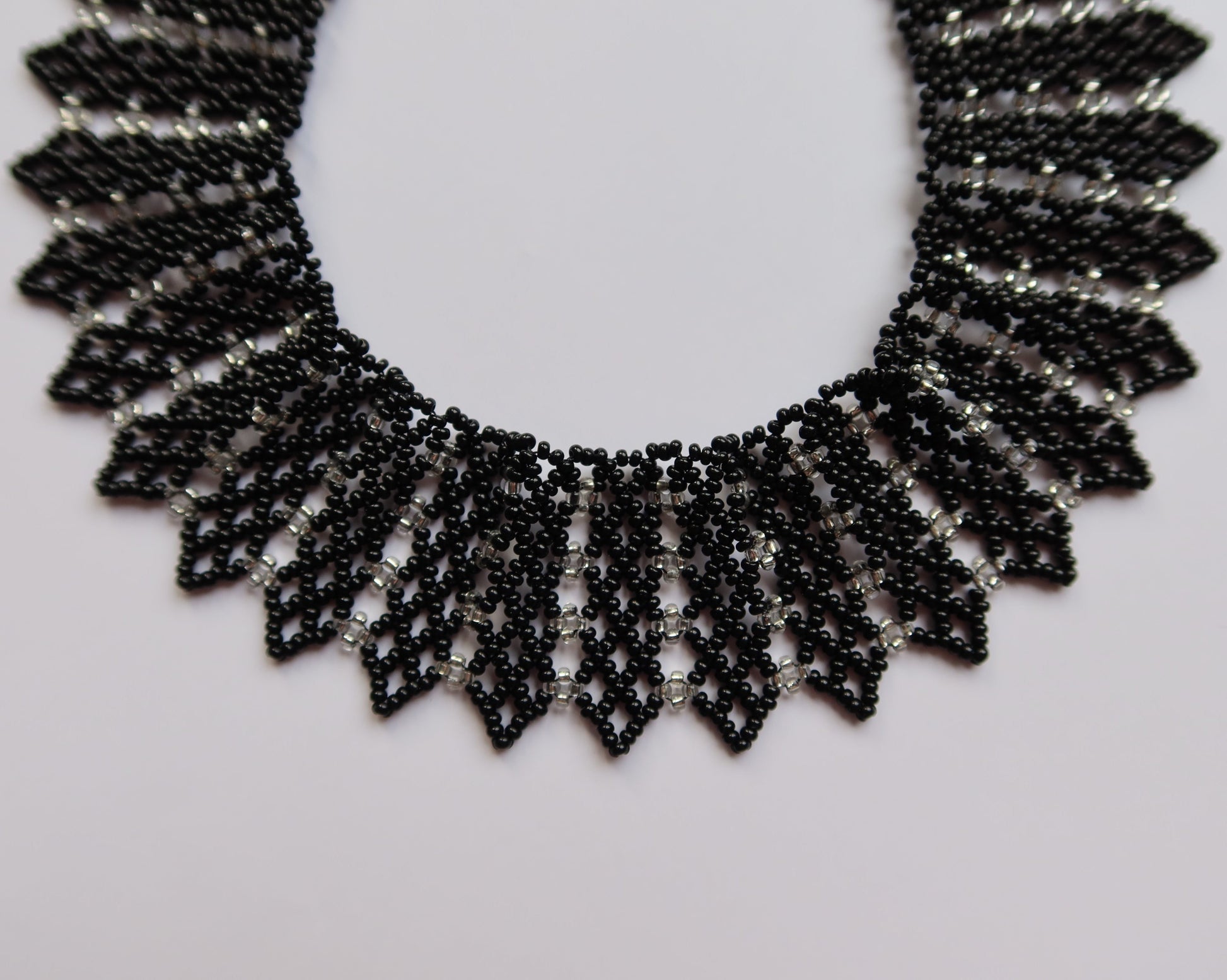 Comely UA black and silver beaded necklace with geometric pattern, inspired by Ukrainian design. Adjustable clasp.