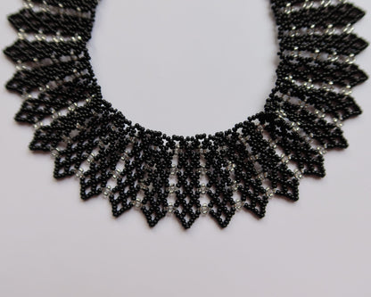 Comely UA black and silver beaded necklace with geometric pattern, inspired by Ukrainian design. Adjustable clasp.