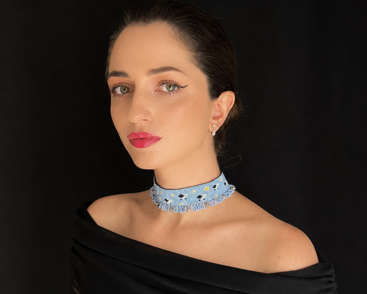 Comely UA light blue beaded choker with white daisies and sheep pattern, featuring a delicate fringe detail.