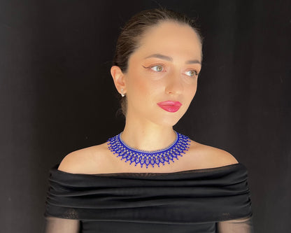 Comely UA blue beaded choker necklace with silver accents, inspired by Ukrainian heritage. Features a flame-like pattern.