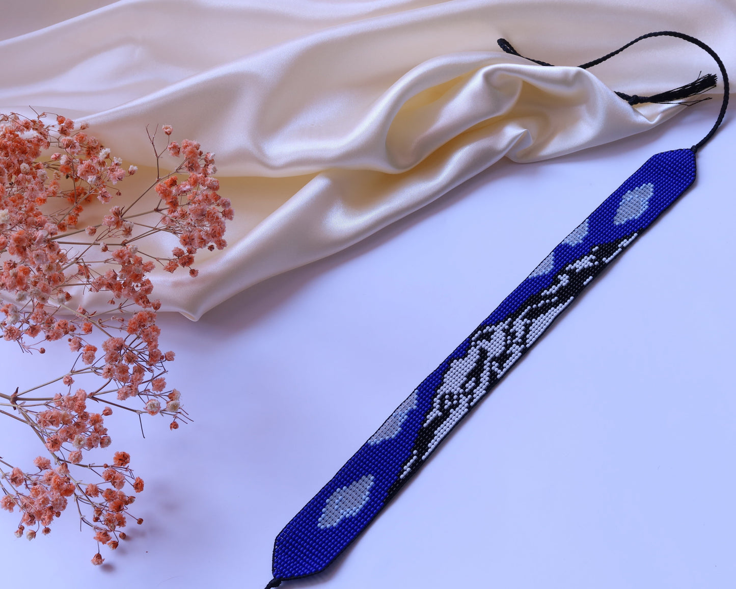 Comely UA blue beaded gerdan with Mont Blanc mountain pattern, white and black accents, adjustable ties with tassels.