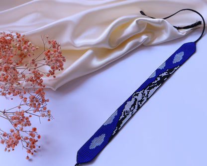 Comely UA blue beaded gerdan with Mont Blanc mountain pattern, white and black accents, adjustable ties with tassels.