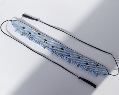 Comely UA sky-blue beaded gerdan with white daisies and sheep pattern, featuring light blue fringe and black tassels.