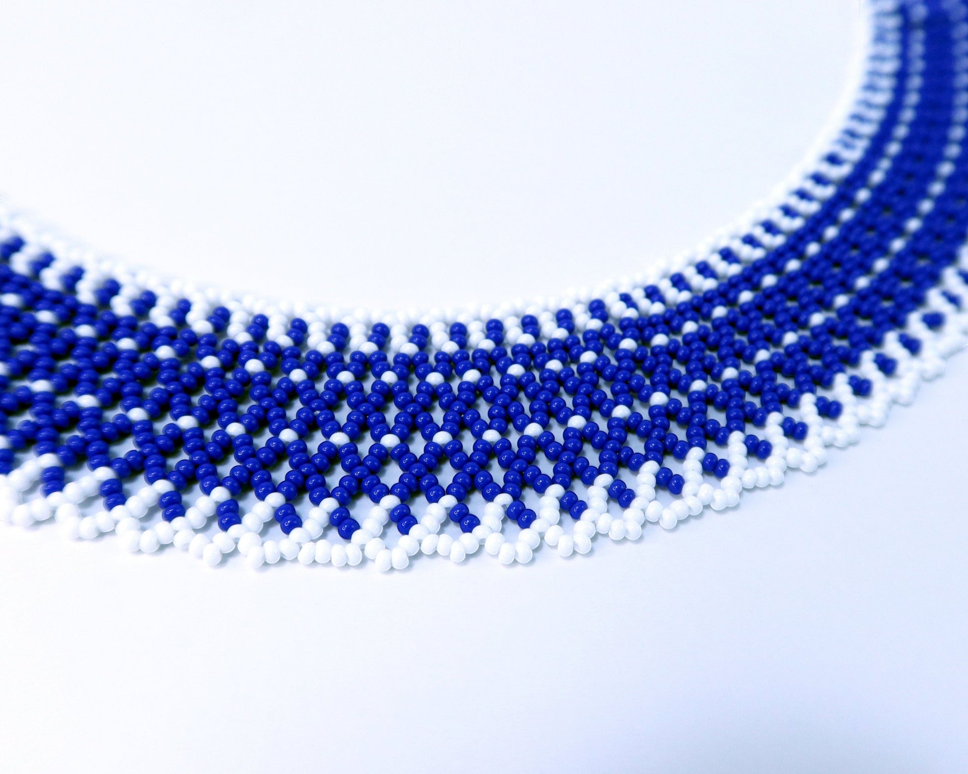 Comely UA blue and white beaded necklace with a linear, net-like pattern. Czech seed beads.