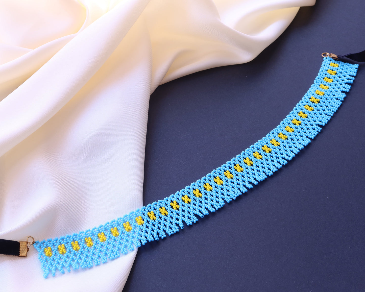 Comely UA blue beaded necklace with yellow geometric accents, inspired by Pokuttian beadwork traditions.