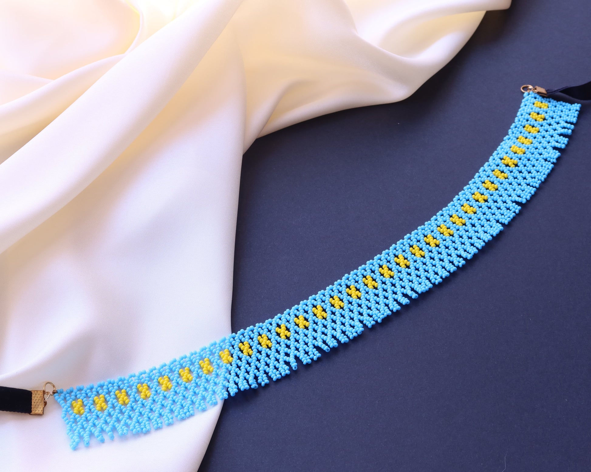 Comely UA blue beaded necklace with yellow geometric accents, inspired by Pokuttian beadwork traditions.