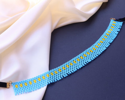 Comely UA blue beaded necklace with yellow geometric accents, inspired by Pokuttian beadwork traditions.