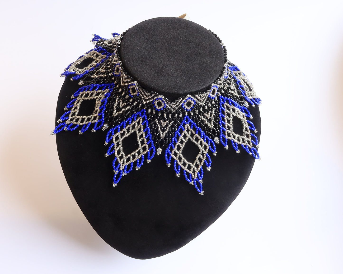 Comely UA Evian beaded necklace with blue, black, and silver diamond patterns. Czech seed beads and velvet ribbon.