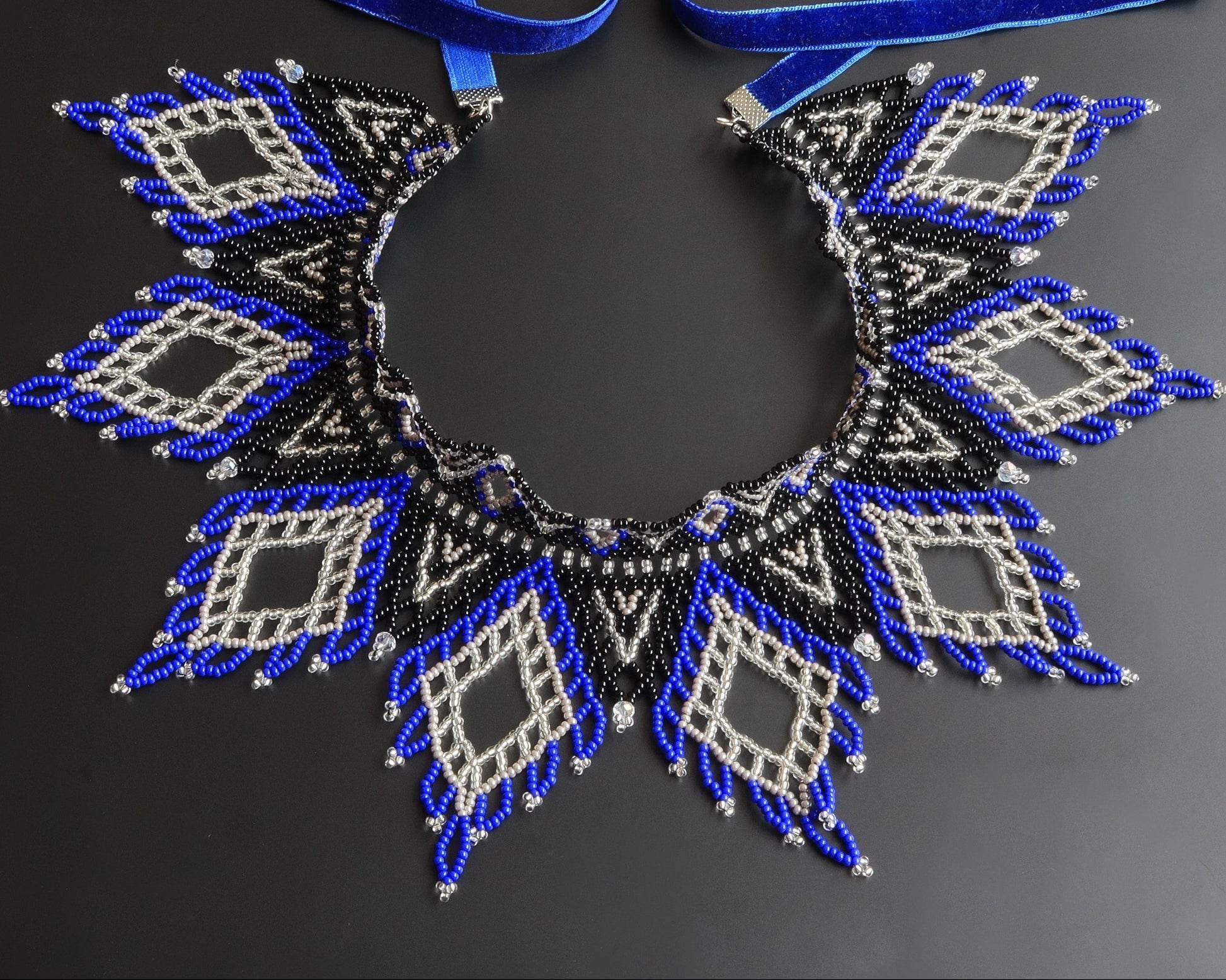 Comely UA Evian beaded necklace with blue, black, and silver diamond patterns and velvet ribbon ties.