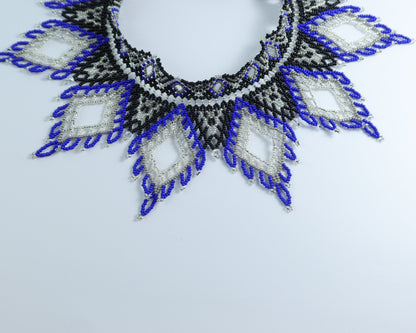 Comely UA Evian beaded necklace with blue, black, and silver diamond patterns. Czech seed beads, nylon thread, velvet ribbon ties.