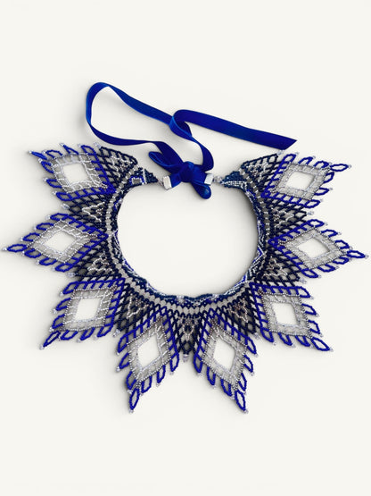 Comely UA Evian beaded necklace with diamond pattern in blue, silver, and black Czech seed beads. Features velvet ribbon ties.