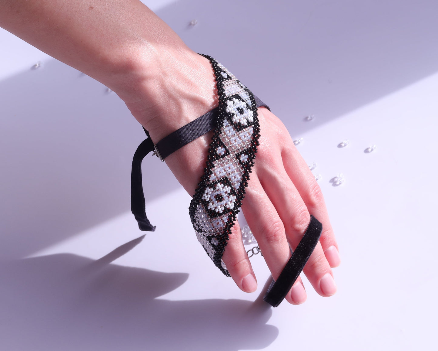 Comely UA beaded gerdan bracelet with black, milk, and clear glass beads in a traditional Hutsul geometric pattern.