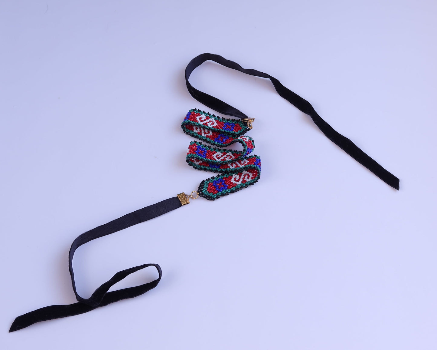 Comely UA Gerdan necklace with red, blue, green, and white diamond beadwork and black velvet ties.