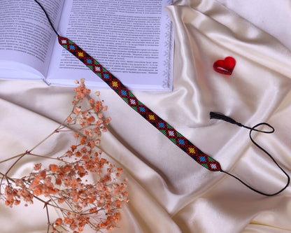 Comely UA beaded gerdan with diamond motif in red, yellow, blue, green, and white. Adjustable tassel cords.